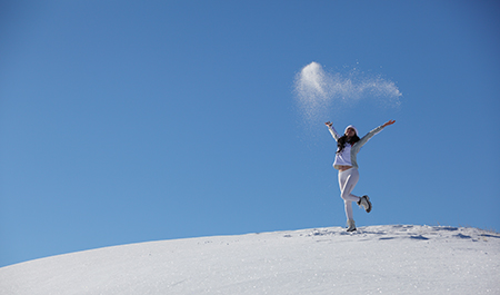 stockvault-young-happy-girl-plays-with-snow117572